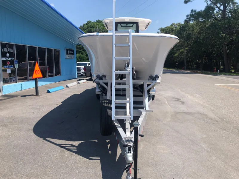 Slide: The Image of 2025 Caymas 30 CT boat on trailer, parked outside dealership. - 8