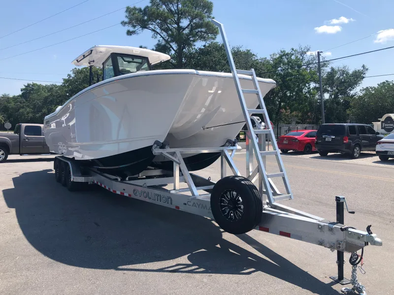 Slide: The Image of 2025 Caymas 30 CT boat on trailer in parking lot. - 9