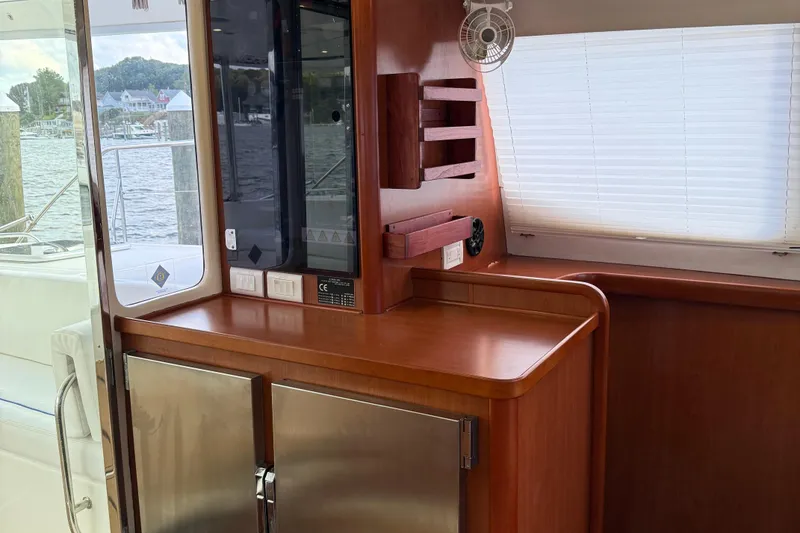 Slide: The Image of Interior of 2012 Leopard 47 PC yacht with wooden cabinetry and stainless steel fridge. - 10
