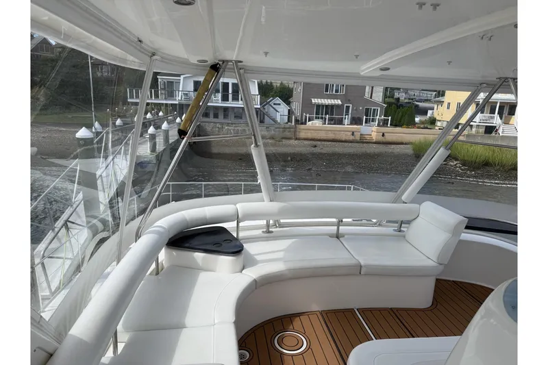 Slide: The Image of Luxurious 2012 Leopard 47 PC yacht interior with white seating and waterfront view. - 20