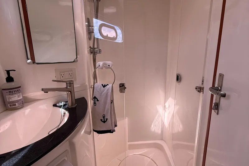 Slide: The Image of Bathroom interior of 2012 Leopard 47 PC Owners' Version yacht, featuring shower and sink. - 32