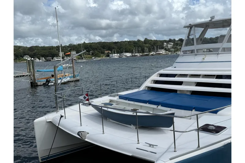 Slide: The Image of 2012 Leopard 47 PC Owners' Version catamaran docked in a scenic harbor. - 37