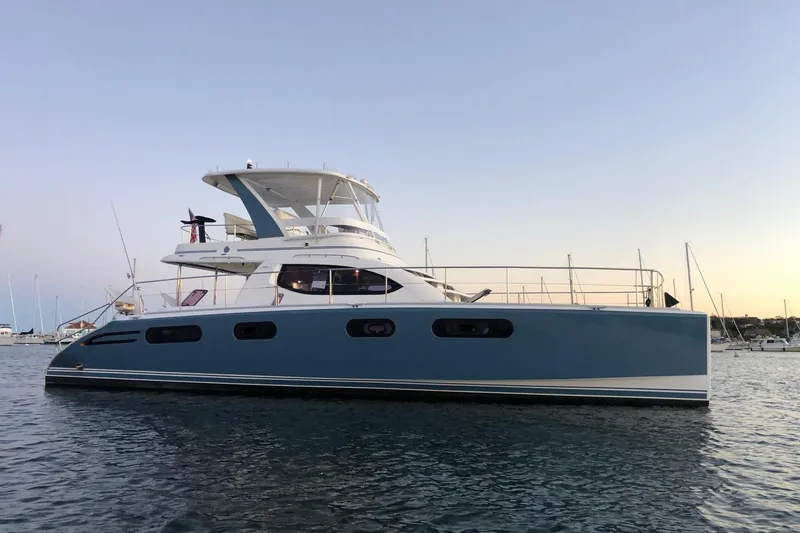 Slide: The Image of 2012 Leopard 47 PC Owners' Version yacht on calm water at sunset. - 4
