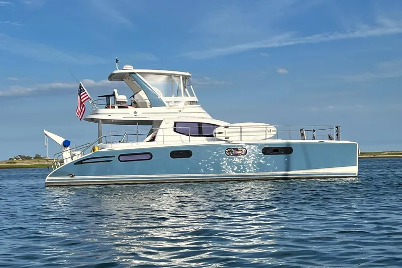 Slide: The Image of 2012 Leopard 47 PC Owners' Version yacht on calm water, American flag displayed. - 40