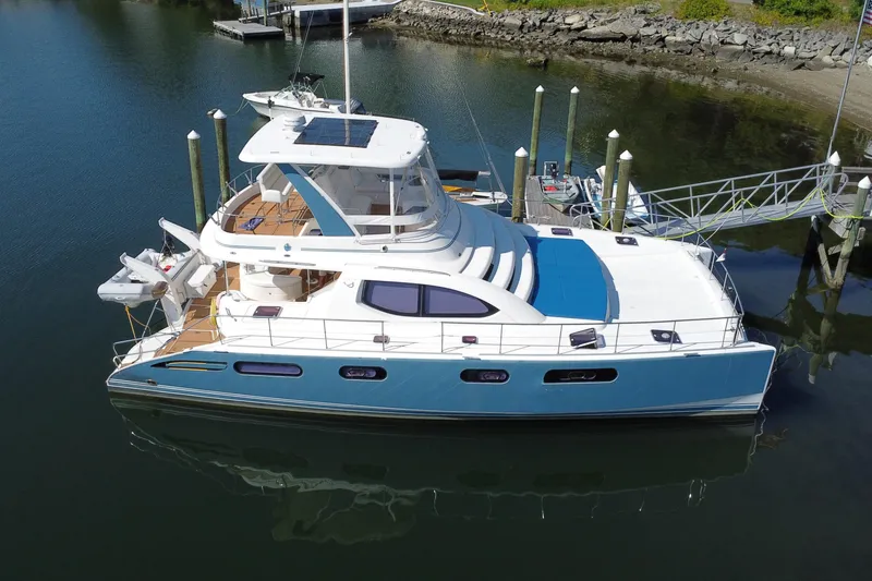 Slide: The Image of 2012 Leopard 47 PC Owners' Version catamaran docked in calm waters. - 42