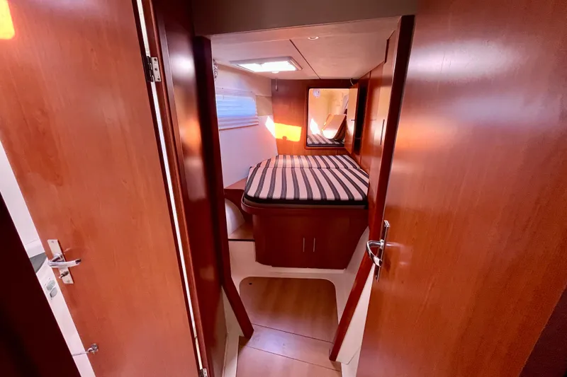 Slide: The Image of Interior cabin of 2012 Leopard 47 PC Owners' Version yacht with striped bedding. - 61