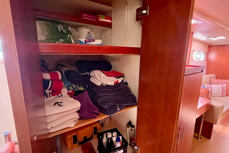 Slide: The Image of Cabin storage in 2012 Leopard 47 PC yacht with neatly organized clothes and toiletries. - 69