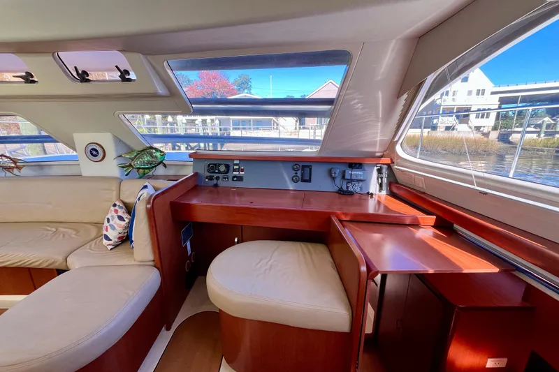 Slide: The Image of Interior of 2012 Leopard 47 PC Owners' Version yacht with plush seating and wooden accents. - 7