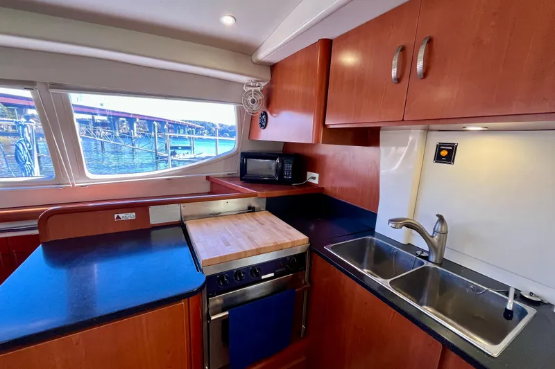 Slide: The Image of Modern kitchen interior of 2012 Leopard 47 PC Owners' Version yacht with wood cabinetry. - 71