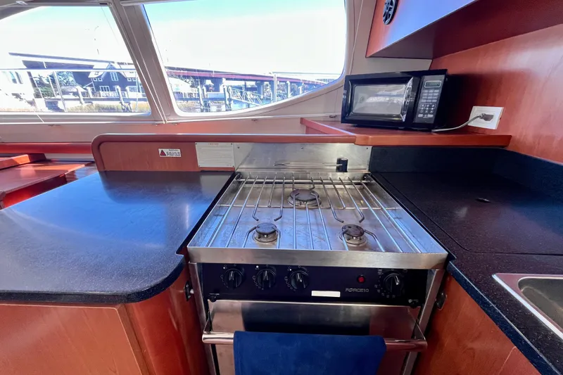 Slide: The Image of Galley kitchen in 2012 Leopard 47 PC Owners' Version yacht with stove and microwave. - 72