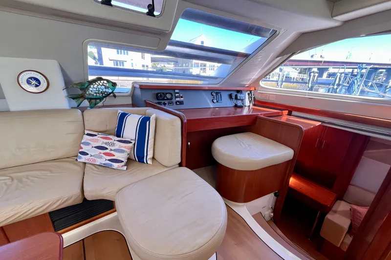 Slide: The Image of Interior of 2012 Leopard 47 PC Owners' Version yacht with beige seating and nautical decor. - 73