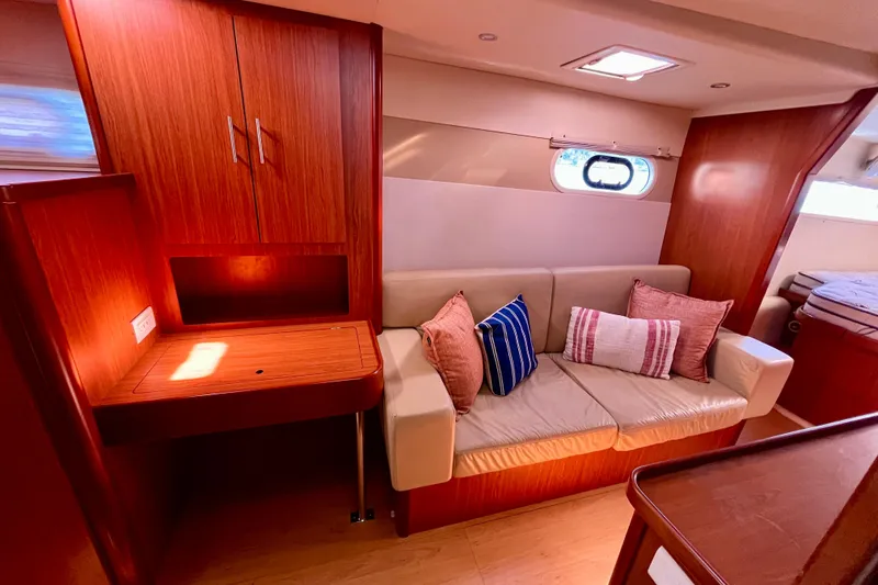 Slide: The Image of Interior of 2012 Leopard 47 PC yacht with cozy seating and wooden cabinetry. - 76