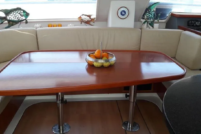 Slide: The Image of Interior of 2012 Leopard 47 PC yacht with wooden table and fruit bowl. - 8