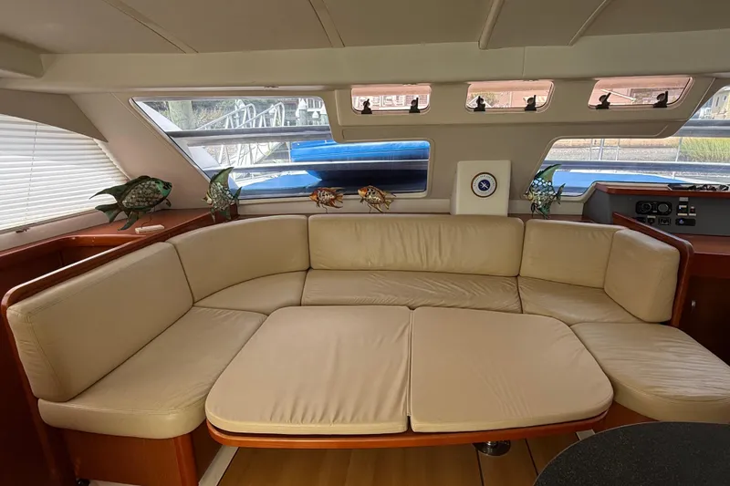 Slide: The Image of Interior of 2012 Leopard 47 PC yacht with beige leather seating and decorative fish accents. - 9