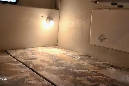 Slide: The Image of 2001 Aquasport 28 Walkaround cabin interior with bed and wall light. - 11