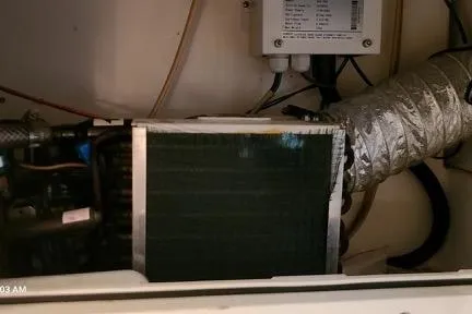 Slide: The Image of Engine compartment of a 2001 Aquasport 28 Walkaround boat, showing mechanical components and ductwork. - 12