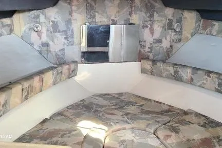 Slide: The Image of 2001 Aquasport 28 Walkaround cabin interior with patterned upholstery and compact layout. - 14