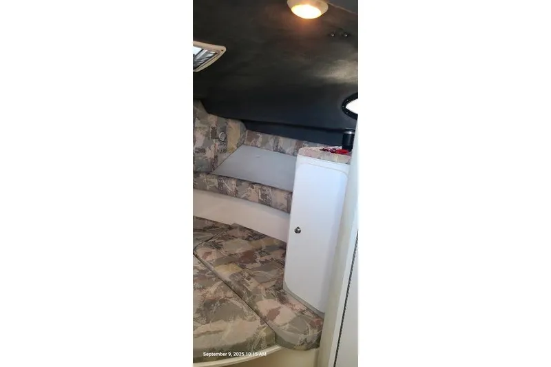 Slide: The Image of Interior cabin of 2001 Aquasport 28 Walkaround boat with patterned seating and storage. - 15