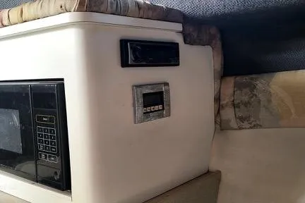 Slide: The Image of 2001 Aquasport 28 Walkaround interior with microwave and control panel. - 18