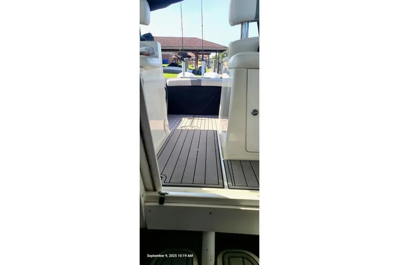 Slide: The Image of 2001 Aquasport 28 Walkaround boat interior with wooden deck and seating area. - 21