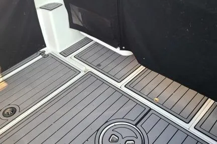 Slide: The Image of 2001 Aquasport 28 Walkaround boat deck with sleek, modern design and durable flooring. - 5