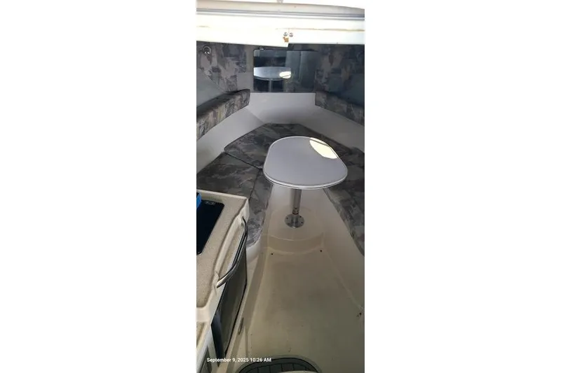 Slide: The Image of 2001 Aquasport 28 Walkaround cabin interior with seating and table. - 8