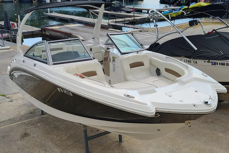 The Image of 2017 Chaparral 244 Sunesta boat docked, showcasing sleek design and spacious seating. - 0