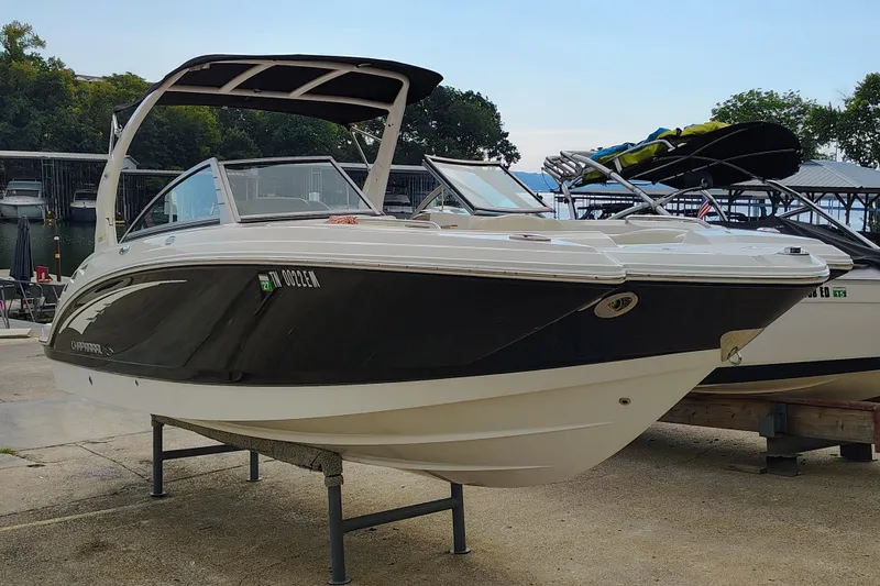 Slide: The Image of 2017 Chaparral 244 Sunesta boat on display at a marina, showcasing sleek design. - 10