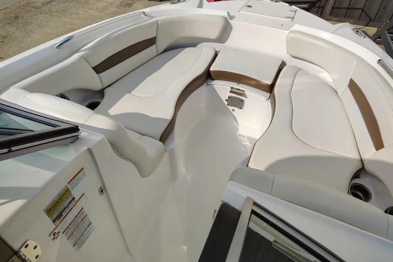 Slide: The Image of 2017 Chaparral 244 Sunesta boat interior with white and brown seating arrangement. - 12