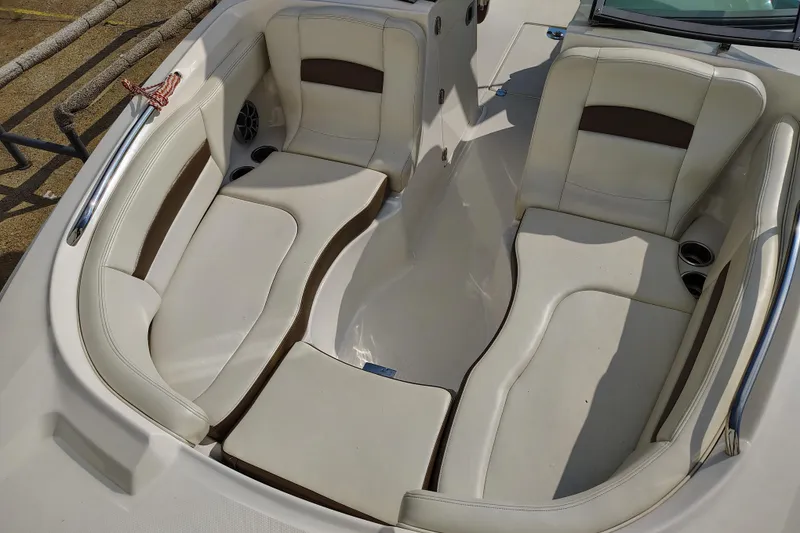 Slide: The Image of 2017 Chaparral 244 Sunesta boat interior with beige seating and cup holders. - 13