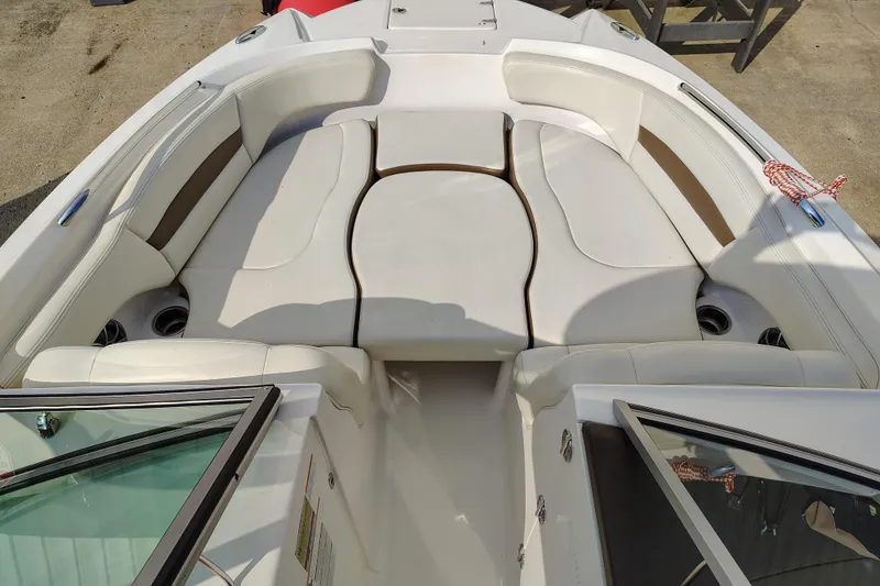 Slide: The Image of 2017 Chaparral 244 Sunesta boat interior with white seating and cup holders. - 14