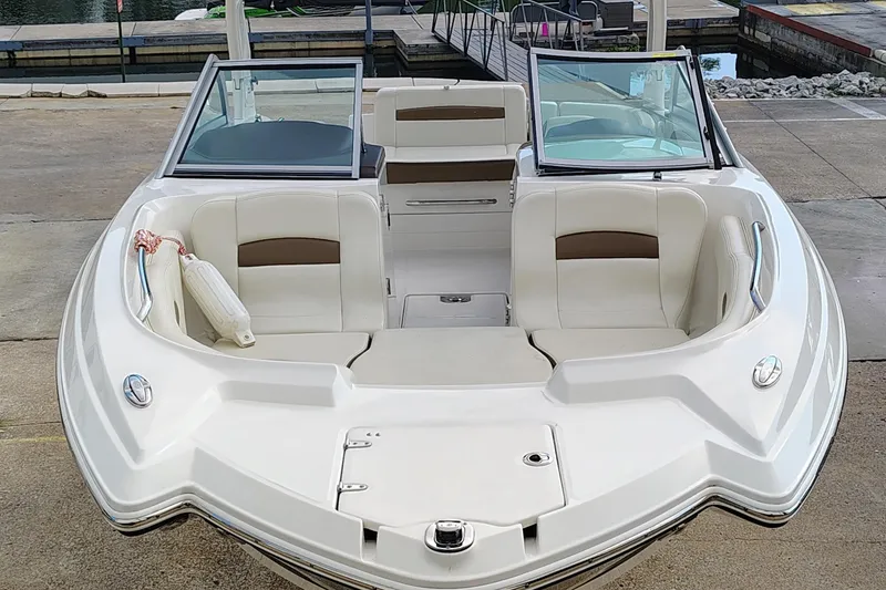 Slide: The Image of 2017 Chaparral 244 Sunesta boat with spacious seating at a dock. - 2
