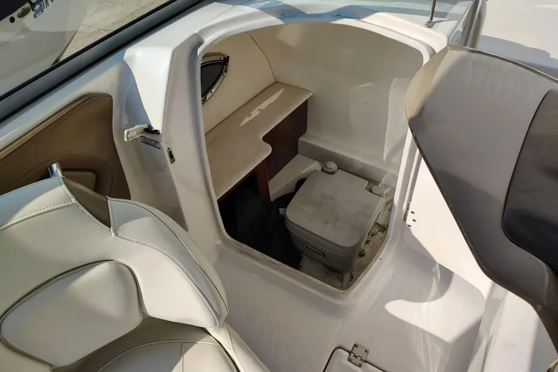 Slide: The Image of 2017 Chaparral 244 Sunesta boat interior with seating and storage compartment. - 21