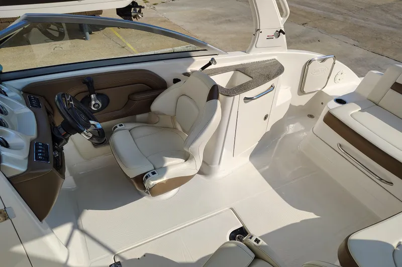 Slide: The Image of 2017 Chaparral 244 Sunesta boat interior with steering wheel and seating area. - 22