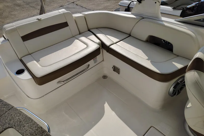 Slide: The Image of 2017 Chaparral 244 Sunesta boat interior with beige and brown seating. - 25
