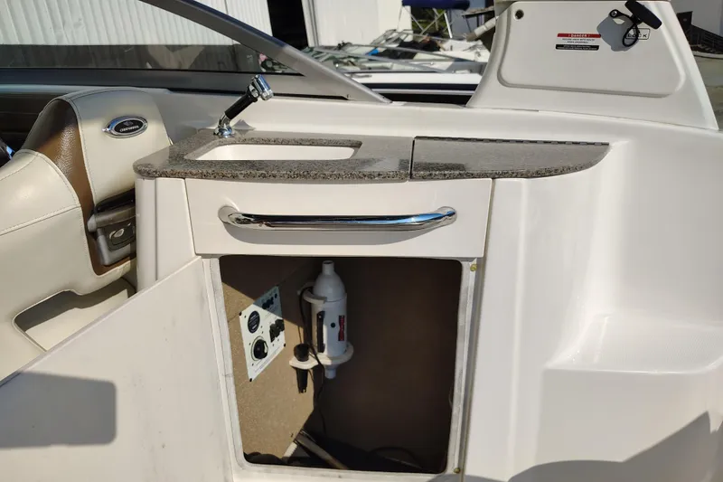 Slide: The Image of 2017 Chaparral 244 Sunesta boat interior with sink and storage compartment. - 28