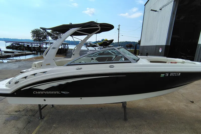 Slide: The Image of 2017 Chaparral 244 Sunesta boat docked near a marina, side view. - 3