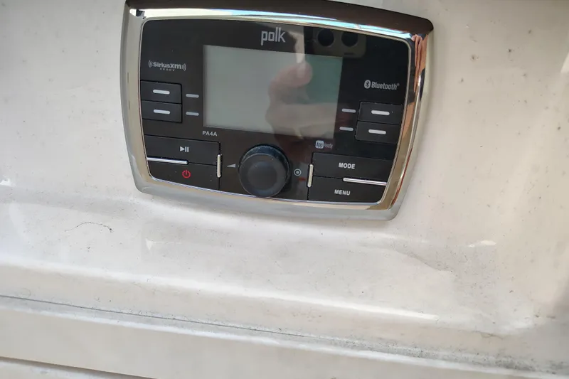 Slide: The Image of Polk audio system on 2017 Chaparral 244 Sunesta boat, featuring Bluetooth and SiriusXM capabilities. - 30