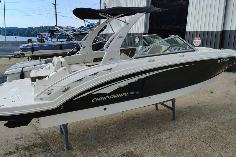 Slide: The Image of 2017 Chaparral 244 Sunesta boat on display at a marina, featuring sleek design. - 4