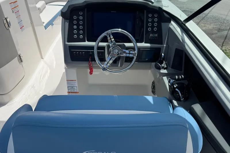 Slide: The Image of 2026 Robalo R317 Dual Console boat cockpit with steering wheel and control panel. - 11