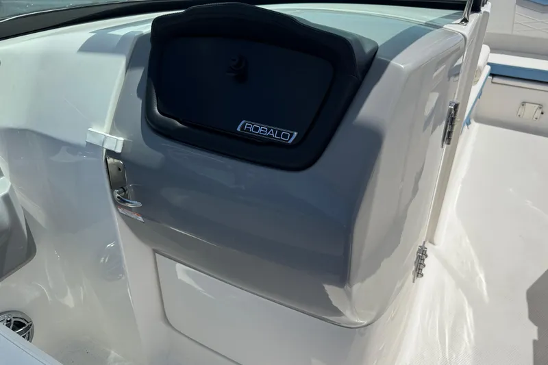 Slide: The Image of 2026 Robalo R317 Dual Console boat interior with sleek design and storage compartment. - 13