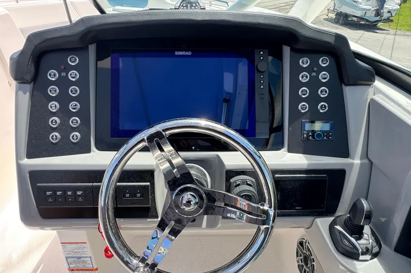 Slide: The Image of 2026 Robalo R317 Dual Console dashboard with steering wheel and control panel. - 17