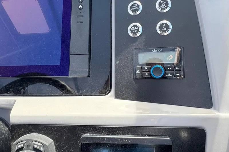 Slide: The Image of Control panel of 2026 Robalo R317 Dual Console boat with Clarion audio system. - 19