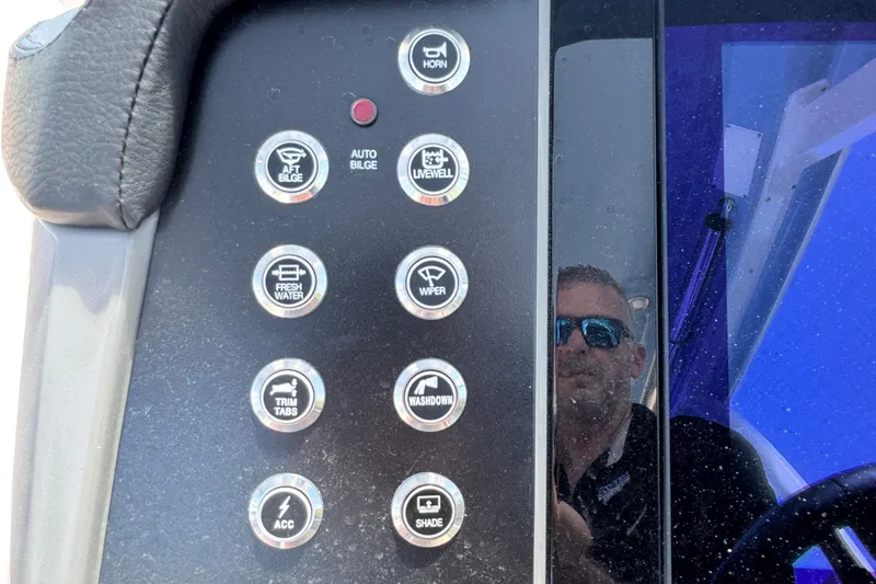 Slide: The Image of Control panel of 2026 Robalo R317 Dual Console boat with various function buttons. - 22
