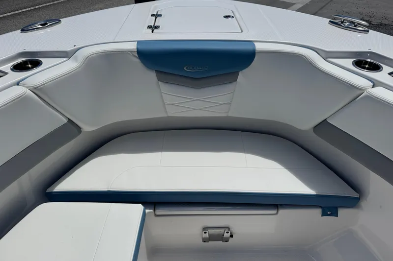 Slide: The Image of 2026 Robalo R317 Dual Console boat interior with cushioned seating and cup holders. - 25