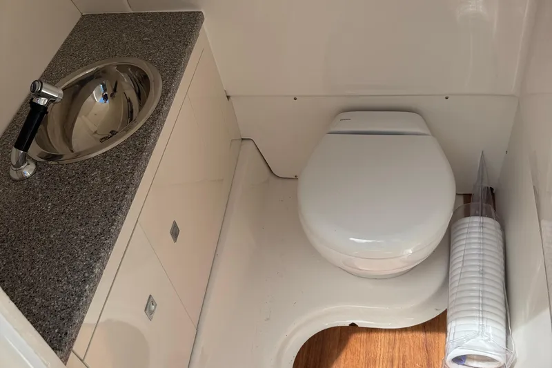Slide: The Image of 2026 Robalo R317 Dual Console boat bathroom with sink and toilet. - 28