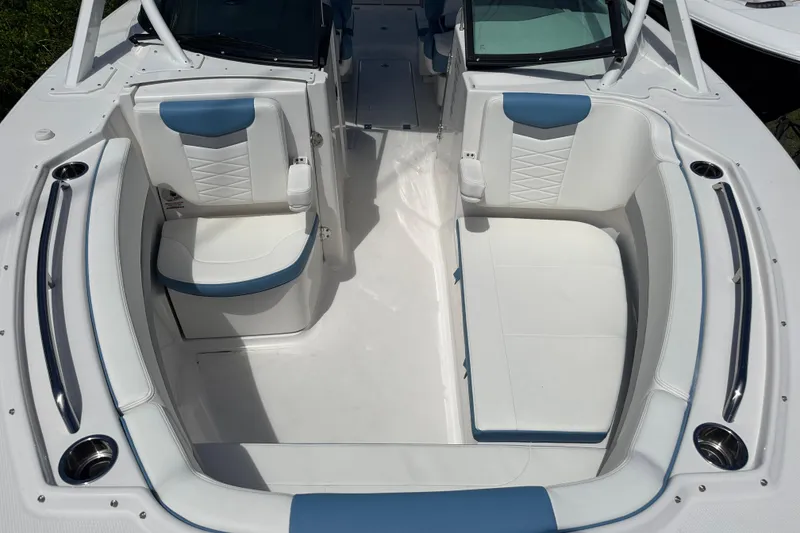 Slide: The Image of 2026 Robalo R317 Dual Console boat interior with white and blue seating. - 29