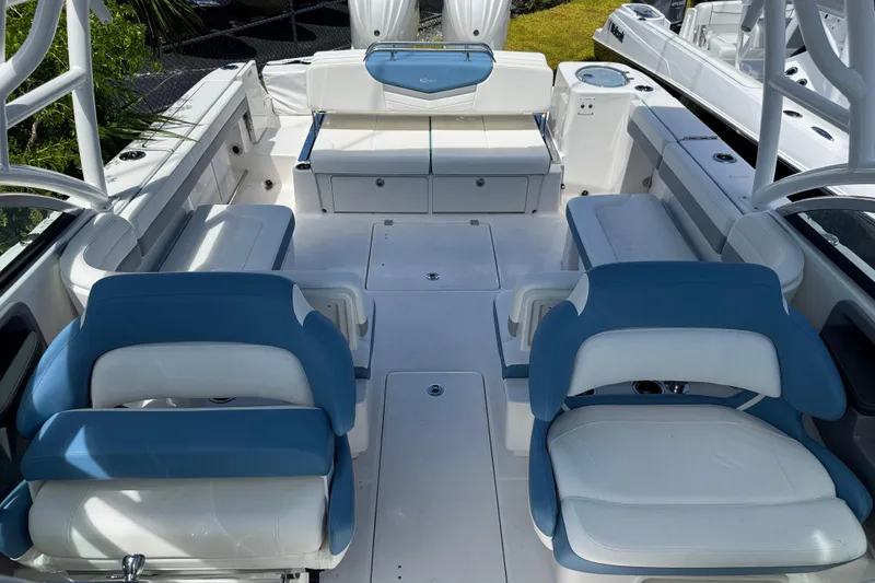 Slide: The Image of 2026 Robalo R317 Dual Console boat interior with blue and white seating arrangement. - 30