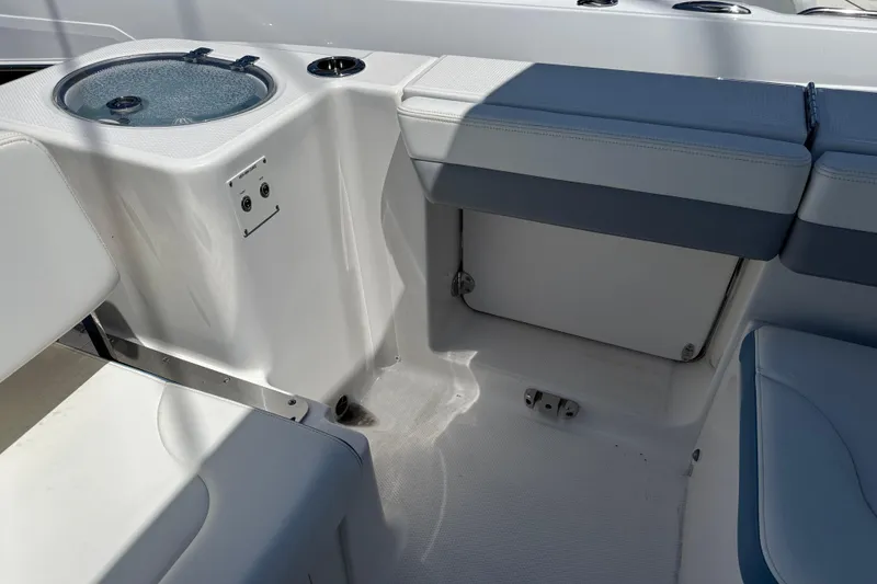 Slide: The Image of 2026 Robalo R317 Dual Console interior seating and storage area. - 6