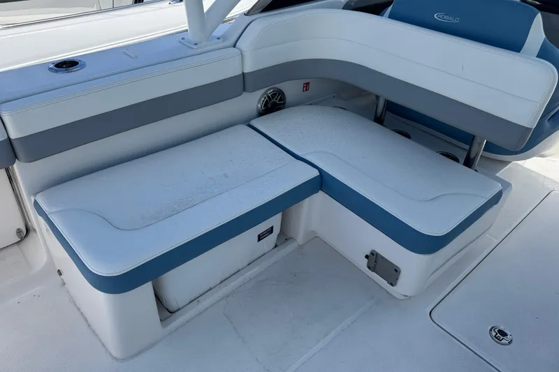 Slide: The Image of 2026 Robalo R317 Dual Console boat seating area with blue and white upholstery. - 7